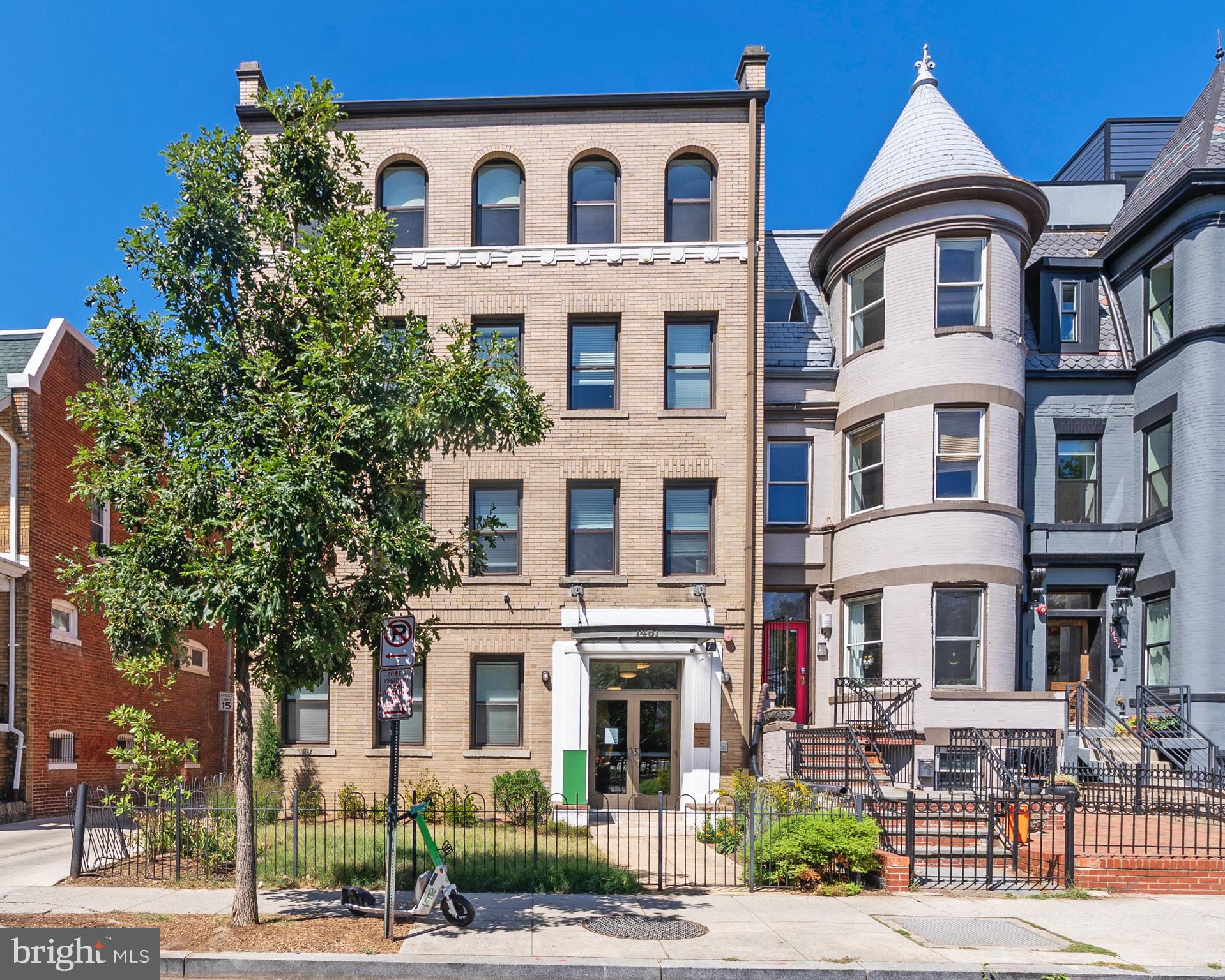 1461 Girard Street Northwest, Unit 201 Washington, DC 20009 - Photo 22 of 24 a view of a white building among the street with palm trees