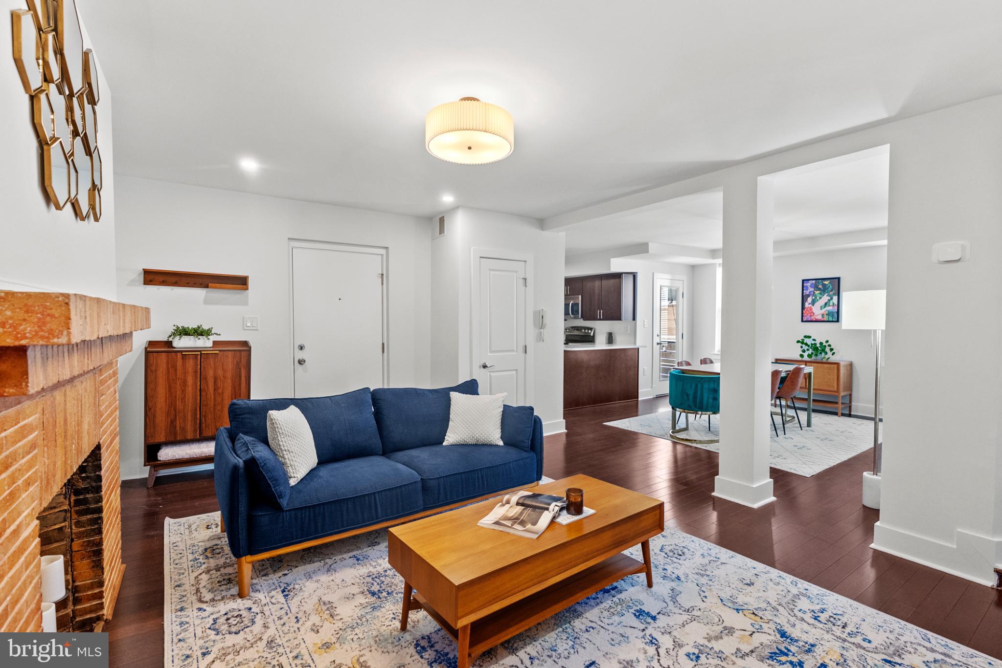 1461 Girard Street Northwest, Unit 201 Washington, DC 20009 - Photo 3 of 24 a living room with furniture a rug and kitchen view