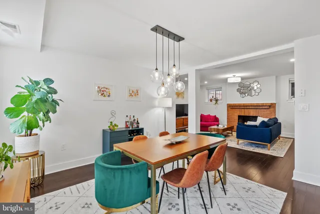 a living room with furniture a chandelier and a fireplace