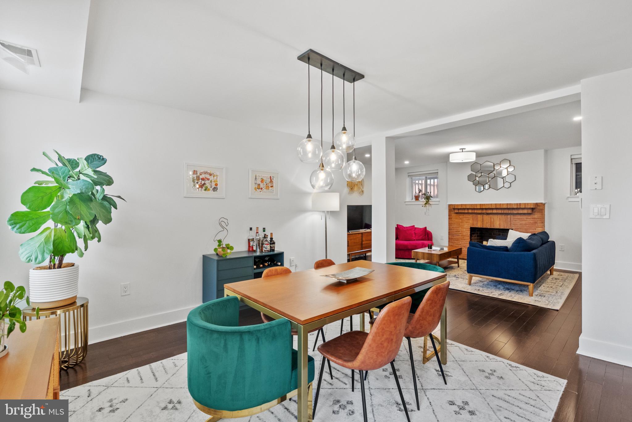 1461 Girard Street Northwest, Unit 201 Washington, DC 20009 - Photo 4 of 24 a living room with furniture a chandelier and a fireplace