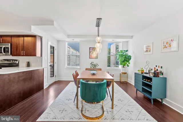 a living room with kitchen furniture and a wooden floor