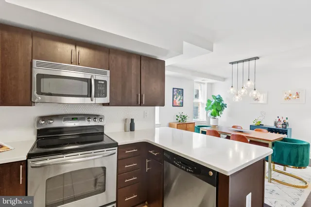 a kitchen with a stove microwave and sink