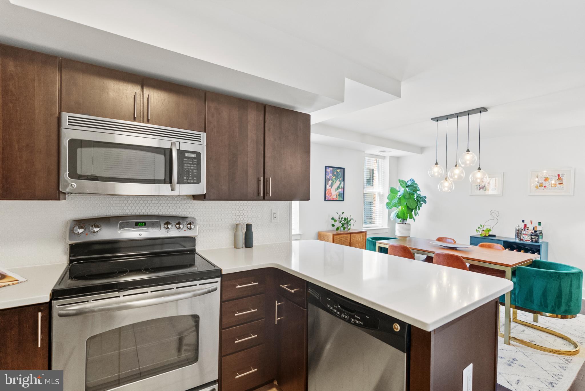 1461 Girard Street Northwest, Unit 201 Washington, DC 20009 - Photo 8 of 24 a kitchen with a stove microwave and sink