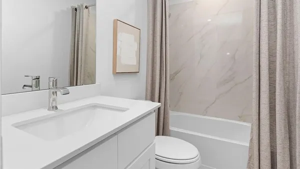 a bathroom with a sink toilet vanity and shower
