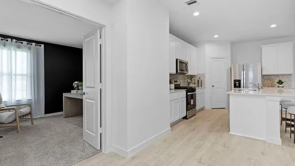a kitchen with a refrigerator and a stove top oven