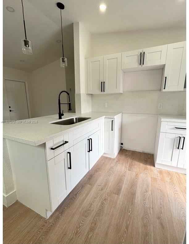 2838 Northwest 4th Street Pompano Beach, FL 33069 - Photo 6 of 10 a kitchen with white cabinets appliances and sink