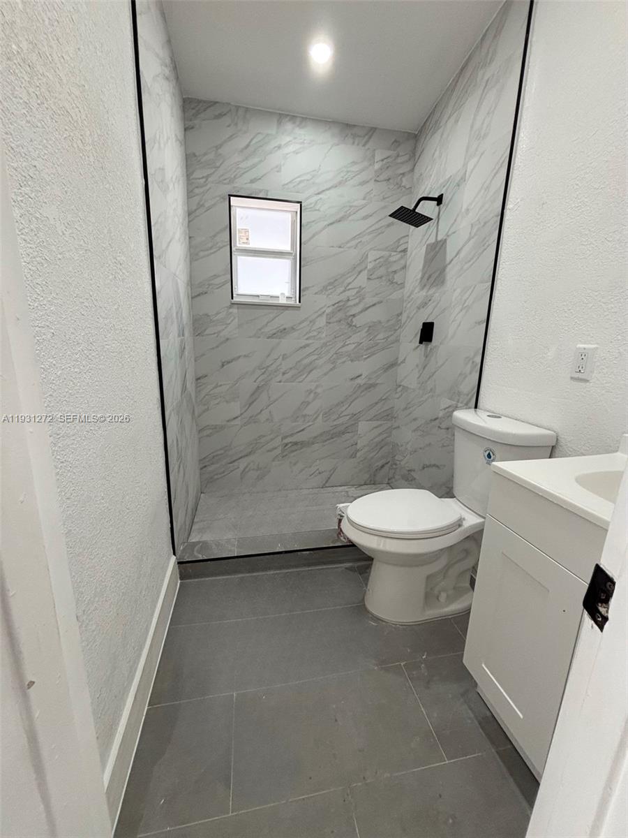 2838 Northwest 4th Street Pompano Beach, FL 33069 - Photo 9 of 10 a bathroom with a toilet and a shower