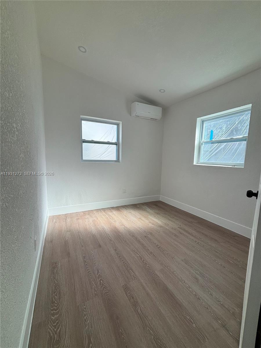 2838 Northwest 4th Street Pompano Beach, FL 33069 - Photo 10 of 10 a view of an empty room with wooden floor and a window