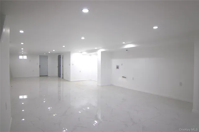 a view of an empty room with a kitchen