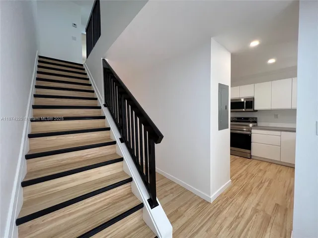 a kitchen with stainless steel appliances granite countertop a refrigerator and a stove top oven