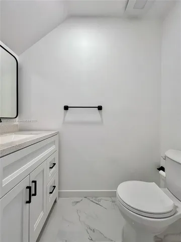 a view of backyard with potted plants and wooden fence