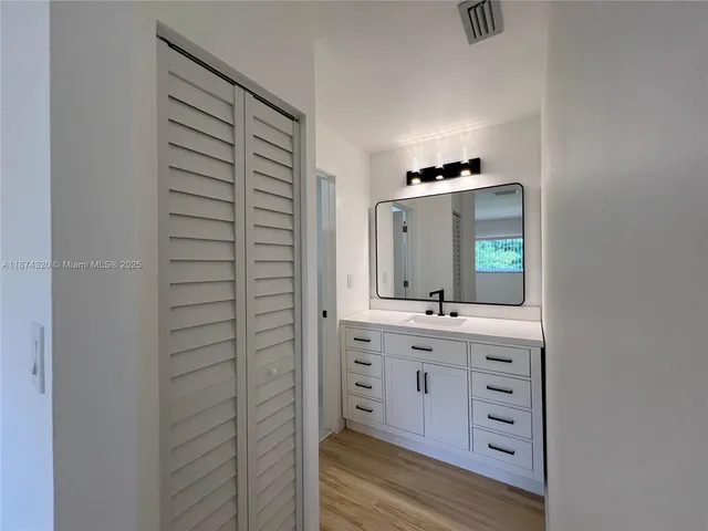 a white toilet sitting next to a shower