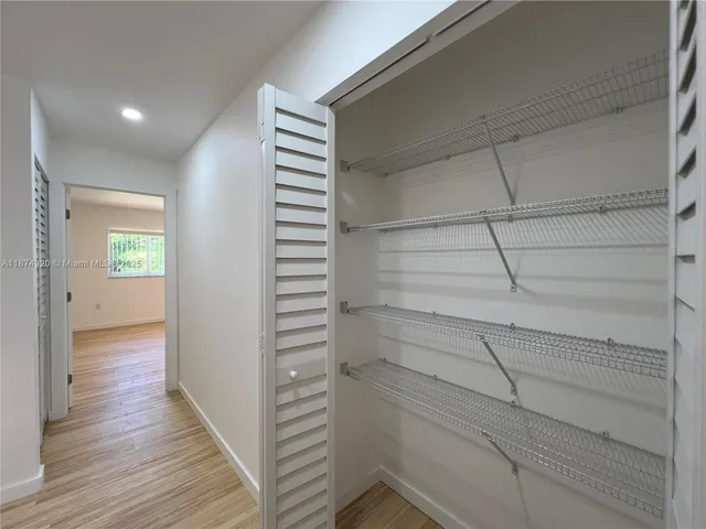a view of a room with wooden floor