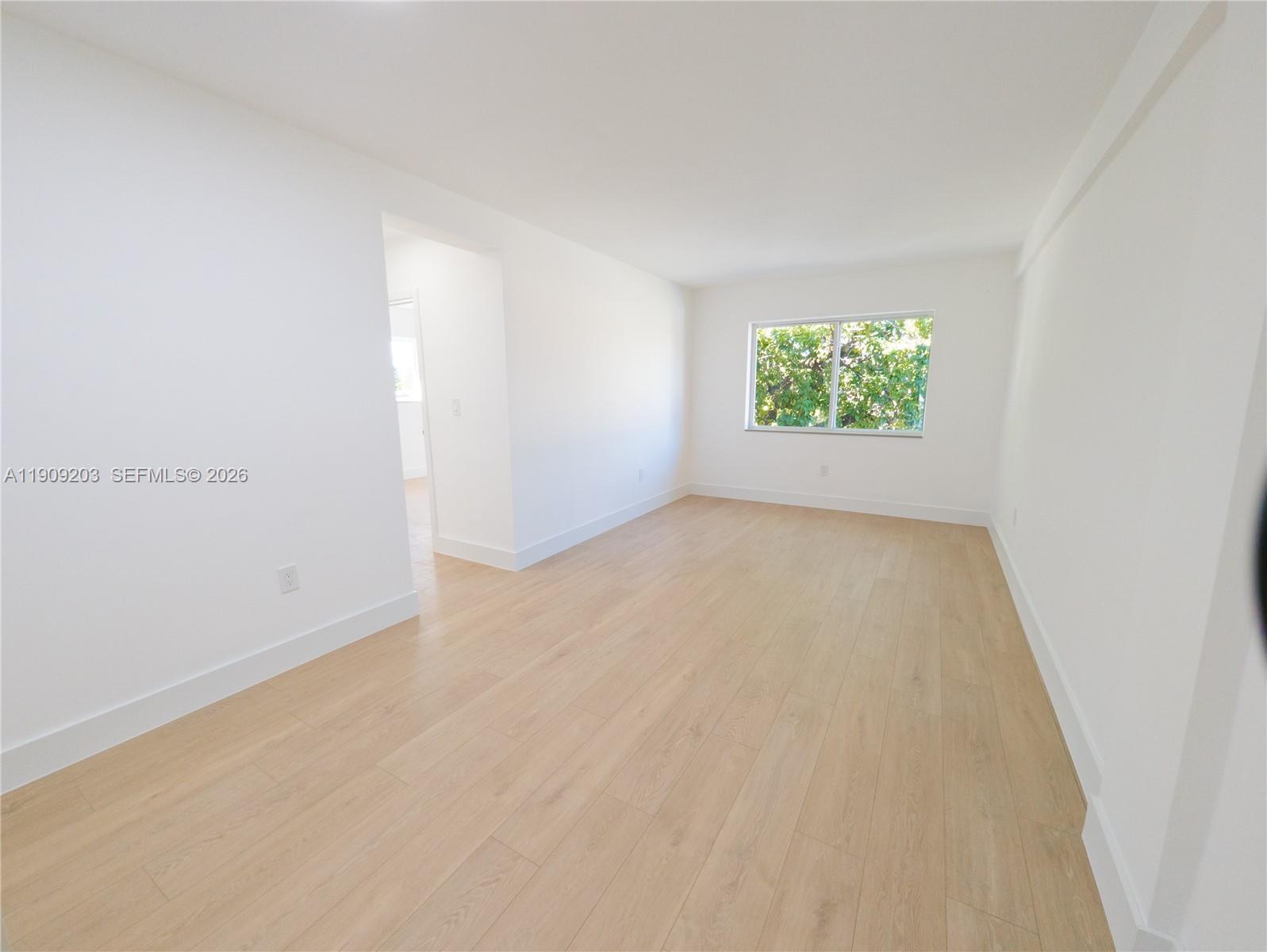 2000 Northwest 29th Street, Unit 1 Miami, FL 33142 - Photo 3 of 7 an empty room with windows