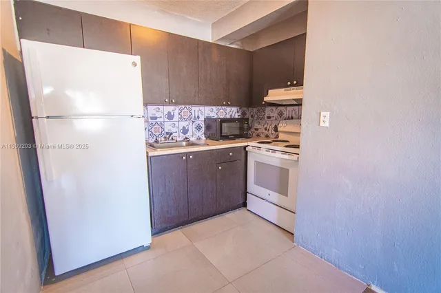 a kitchen with stainless steel appliances a refrigerator and a stove