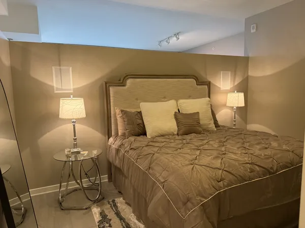 a bedroom with a bed and a lamp