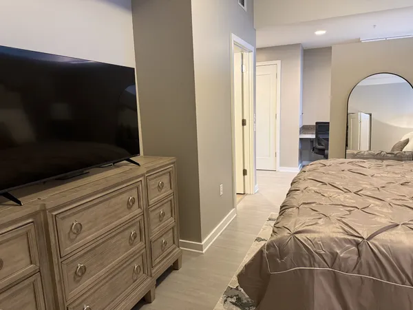 a bedroom with a bed and a flat screen tv