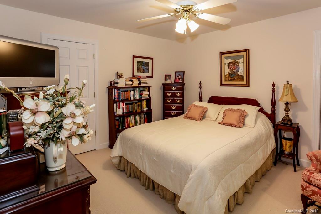 321 Ridgeview Drive Rutherfordton, NC 28139 - Photo 16 of 25 a bedroom with a large bed and a flat tv screen on dresser