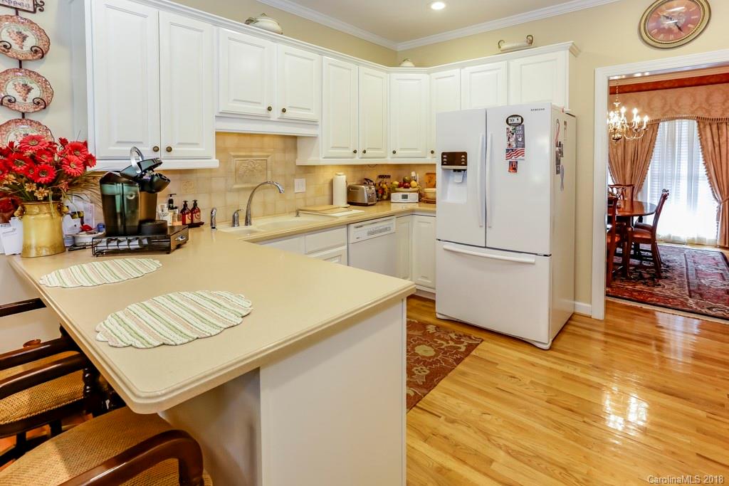 321 Ridgeview Drive Rutherfordton, NC 28139 - Photo 8 of 25 a kitchen with a refrigerator a stove a sink and a dining table with wooden floor