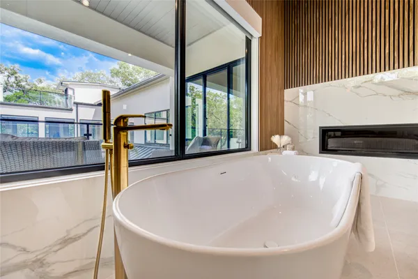 a white bath tub sitting in front of a window