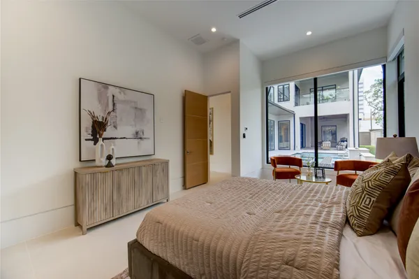 a bedroom with bed and glass windows