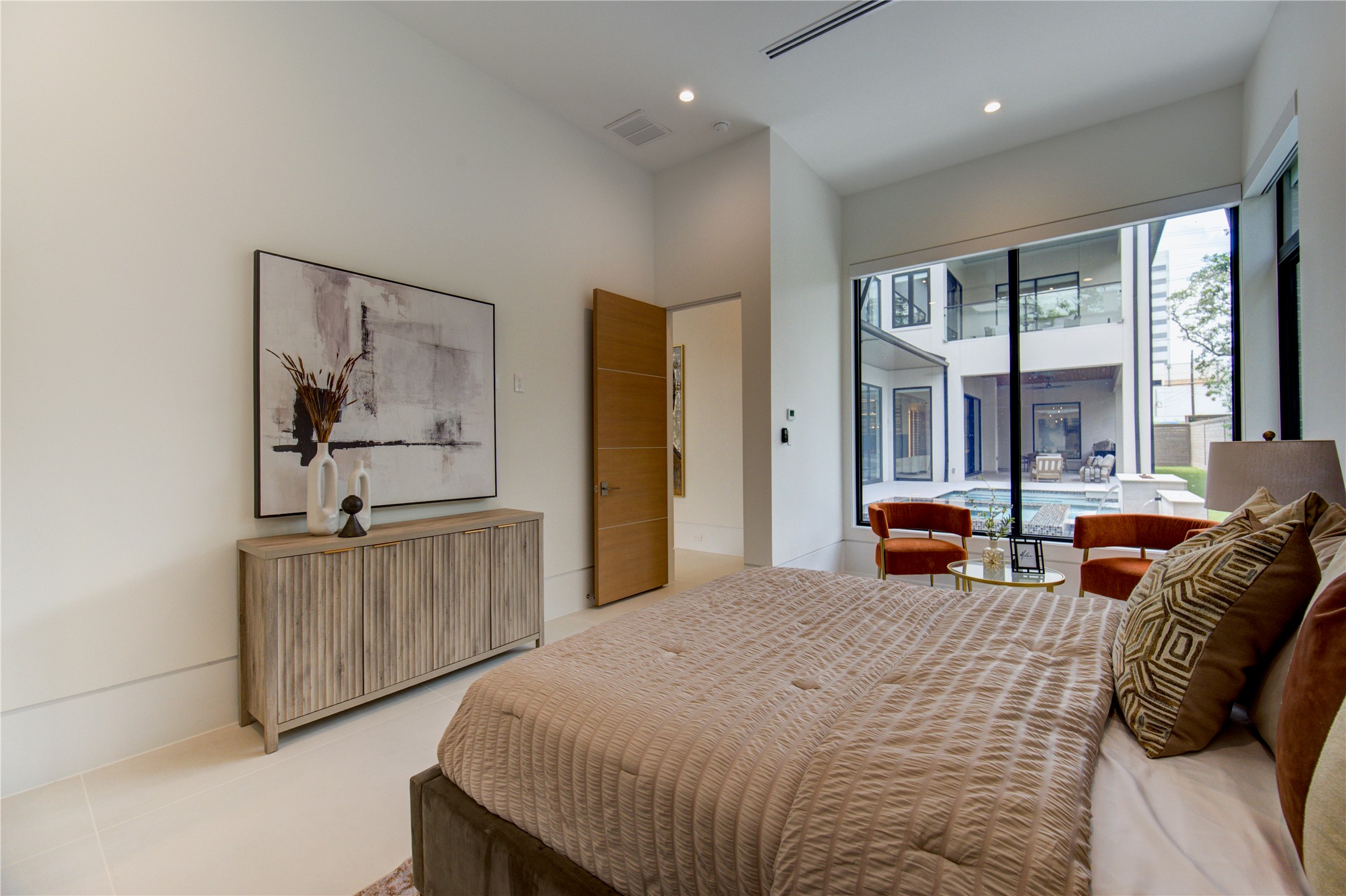 2006 Suffolk Drive Houston, TX 77027 - Photo 20 of 29 a bedroom with bed and glass windows