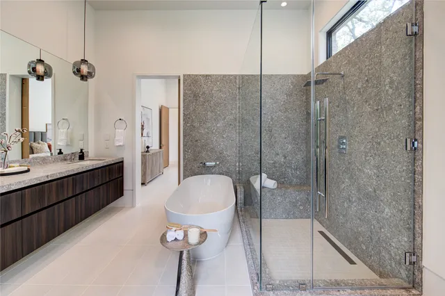 a bathroom with a double vanity sink toilet mirror and shower