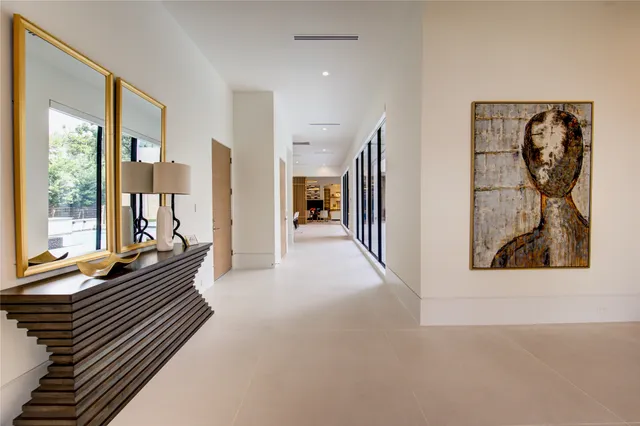 a view of a hallway with wooden floor and windows