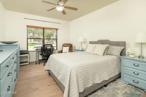 a bedroom with a bed and a chandelier