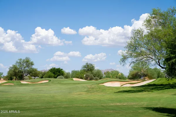 a view of a golf course with an trees