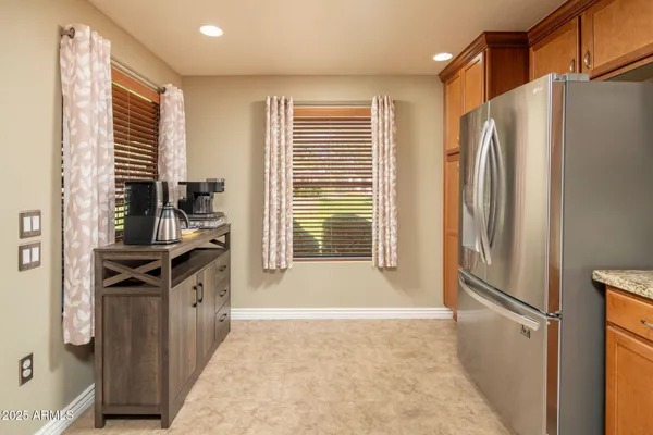 a kitchen with stainless steel appliances granite countertop a refrigerator and a sink