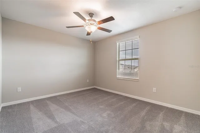 a bathroom with a granite countertop bathtub shower sink vanity mirror and toilet