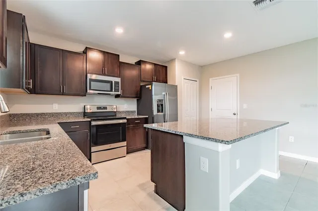 a kitchen with cabinets appliances and a sink