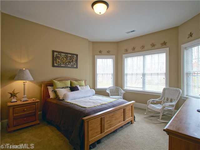 8500 Crested Oak Court Oak Ridge, NC 27310 - Photo 13 of 16 4th Bedroom. Guests will love their own private getaway complete bedroom and private bath in the walk out basement. Here you will also find loads of storage finished and unfinished.