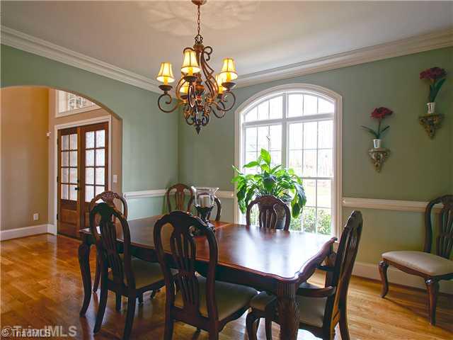 8500 Crested Oak Court Oak Ridge, NC 27310 - Photo 3 of 16 Dining Room. The formal dining room is just off the foyer; with an arched entry that mimics the arched transom above the triple windows, this room is simply elegant and naturally light.