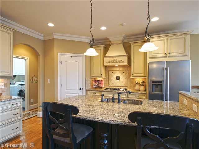 8500 Crested Oak Court Oak Ridge, NC 27310 - Photo 6 of 16 Kitchen. The big island is both a natural gathering place and very functional prep area, while the adjacent breakfast room is ideal for casual dining. The island has a rustic deep brown/black finish and the ample cabinets are cream with a chocolate glaze.