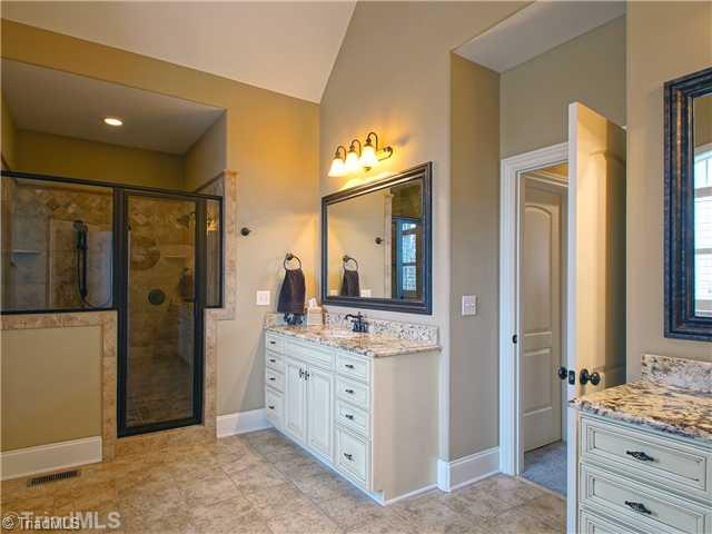 8500 Crested Oak Court Oak Ridge, NC 27310 - Photo 10 of 16 Master Bath/Spa. The bath offers luxury with a jetted tub, oversized shower, separate water closet and two vanities; tile floor and surrounds with decorative accents, oil-rubbed bronze fixtures and a vaulted ceiling provide the finishing touches to the bath.