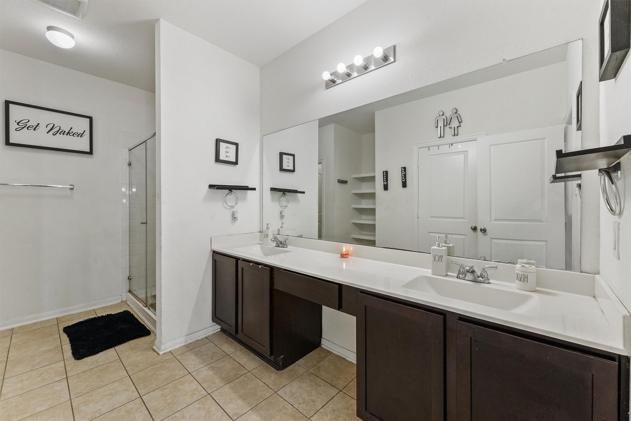 5303 Rivers Edge Drive Richmond, TX 77469 - Photo 6 of 8 a bathroom with a double vanity sink and mirror