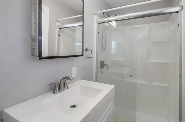 a view of a room with wooden floor and windows