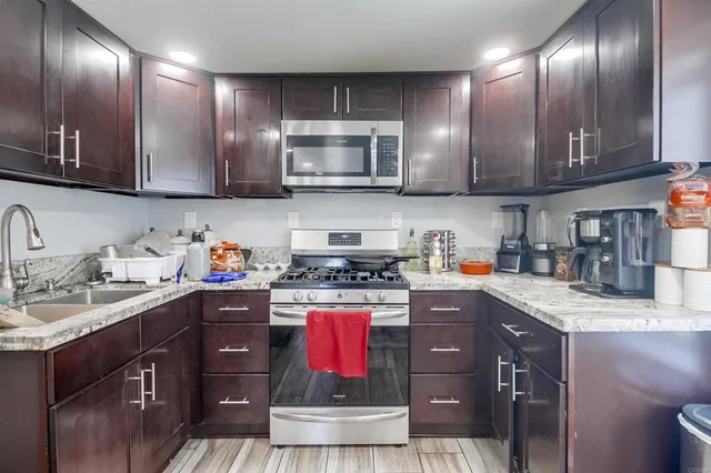 a kitchen with refrigerator cabinets and wooden floor