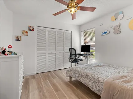 a bedroom with a bed and a desk