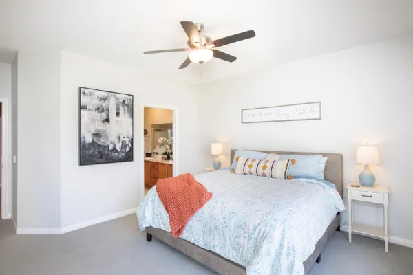 a bedroom with a bed and a painting on the wall