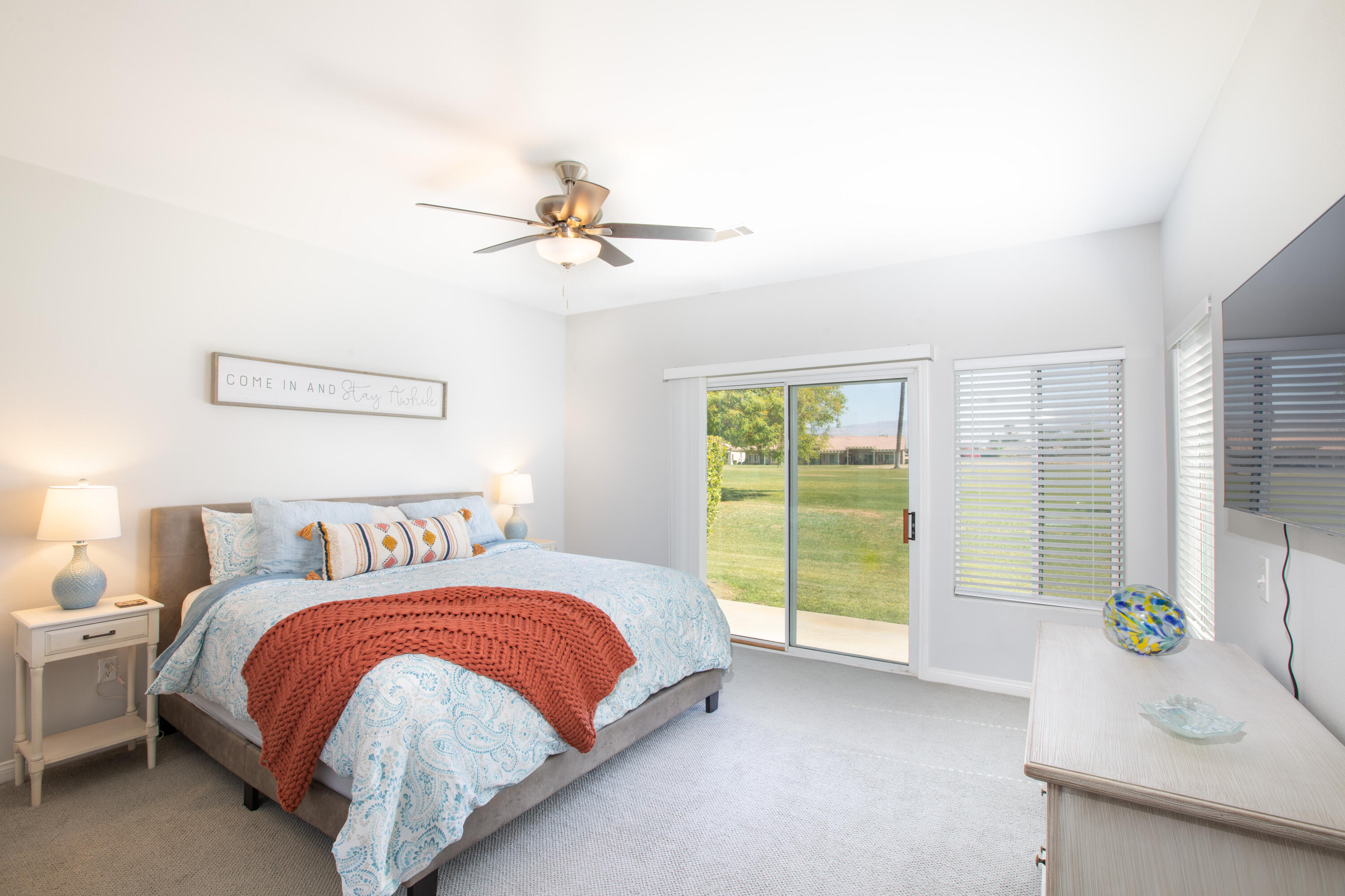 82368 Lancaster Way Indio, CA 92201 - Photo 12 of 35 a bedroom with a balcony a bed and a chandelier