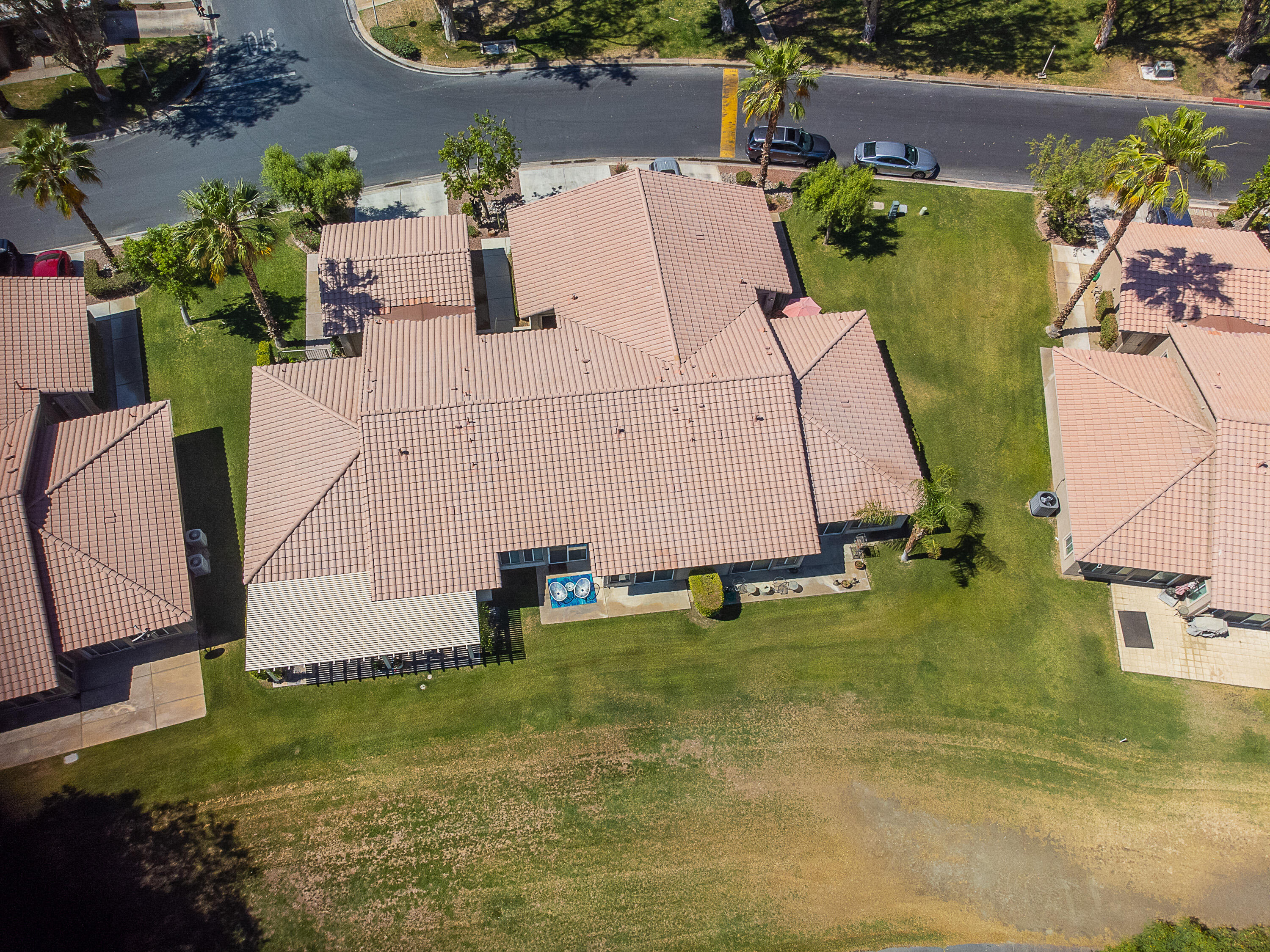 82368 Lancaster Way Indio, CA 92201 - Photo 31 of 35 an aerial view of a house with swimming pool and large trees