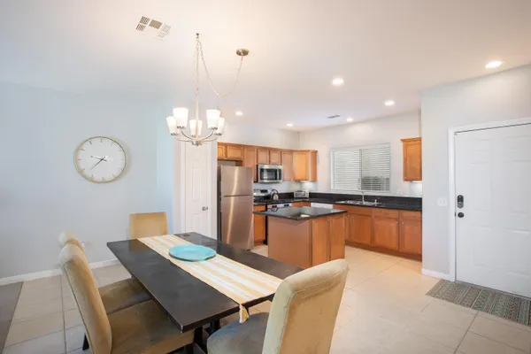 a large kitchen with a table and chairs