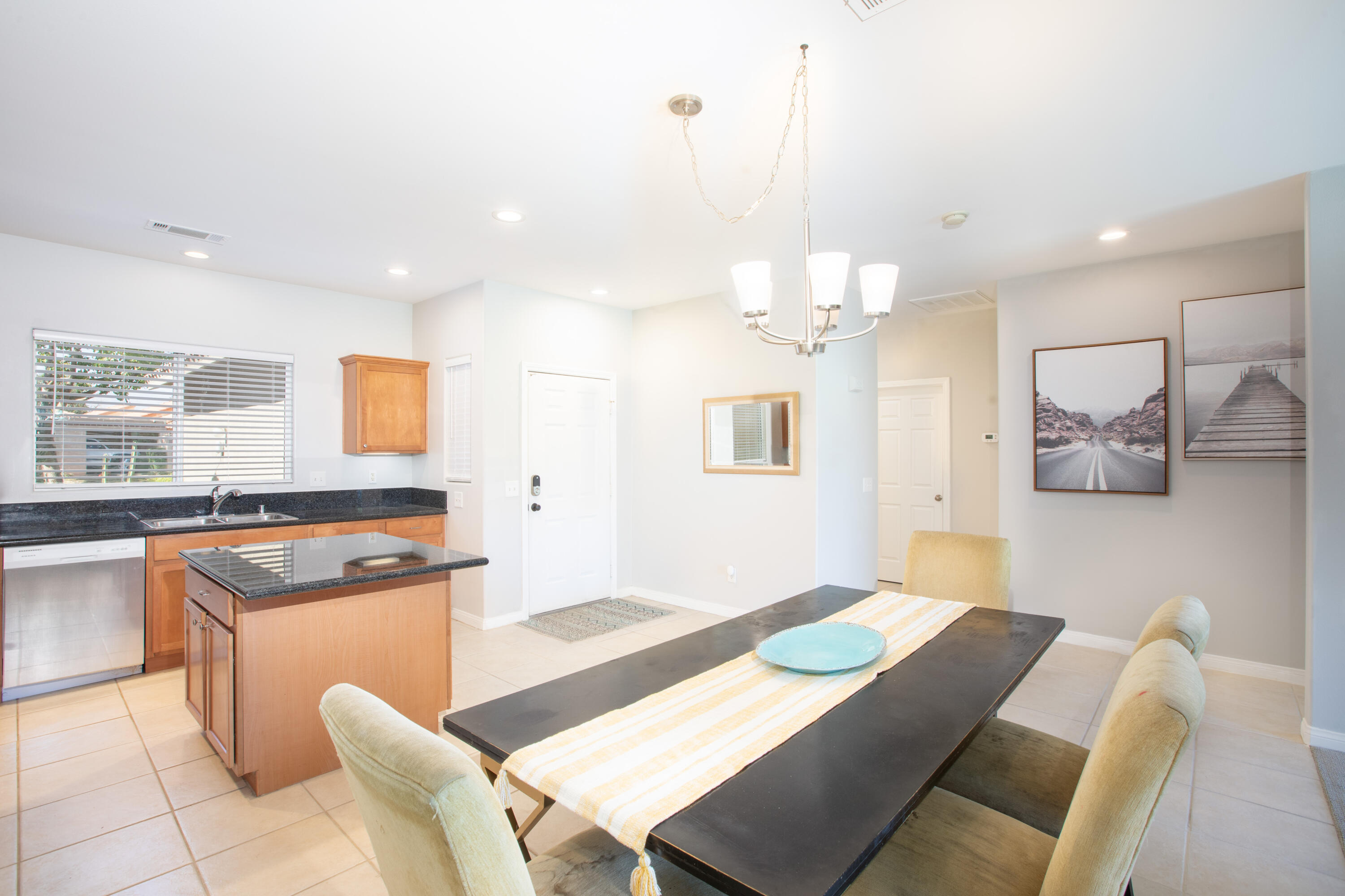 82368 Lancaster Way Indio, CA 92201 - Photo 6 of 35 a living room with furniture and a chandelier