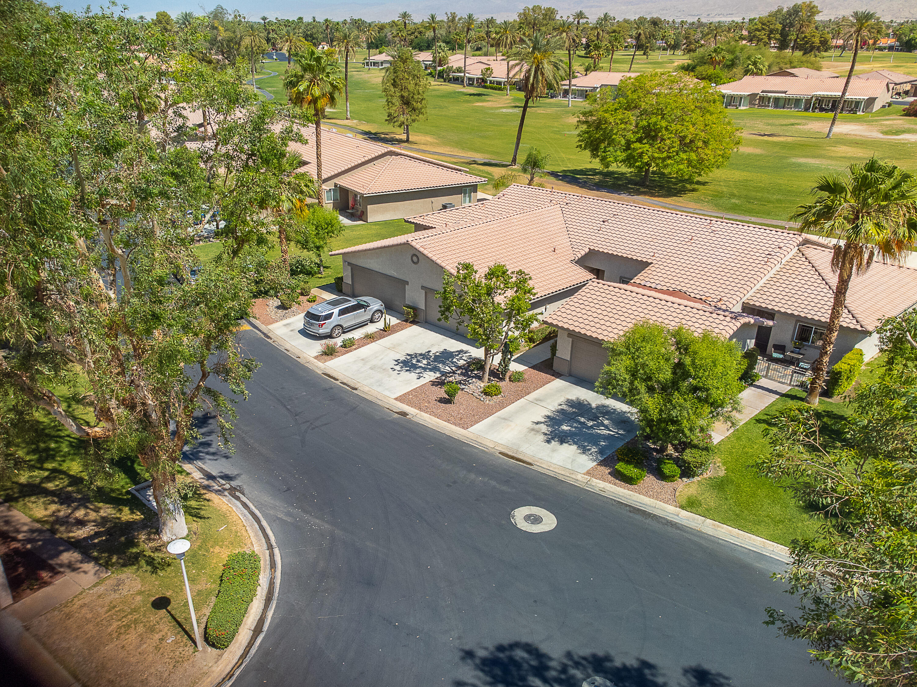 82368 Lancaster Way Indio, CA 92201 - Photo 8 of 35 an aerial view of a house with a garden and lake view