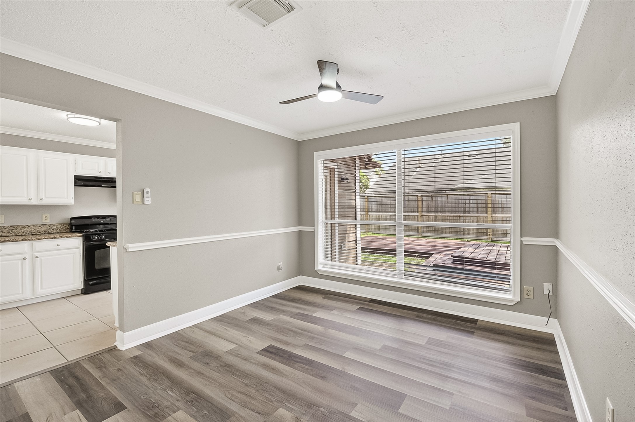 12403 Meadow Ridge Drive Stafford, TX 77477 - Photo 11 of 47 a view of an empty room with a window and wooden floor