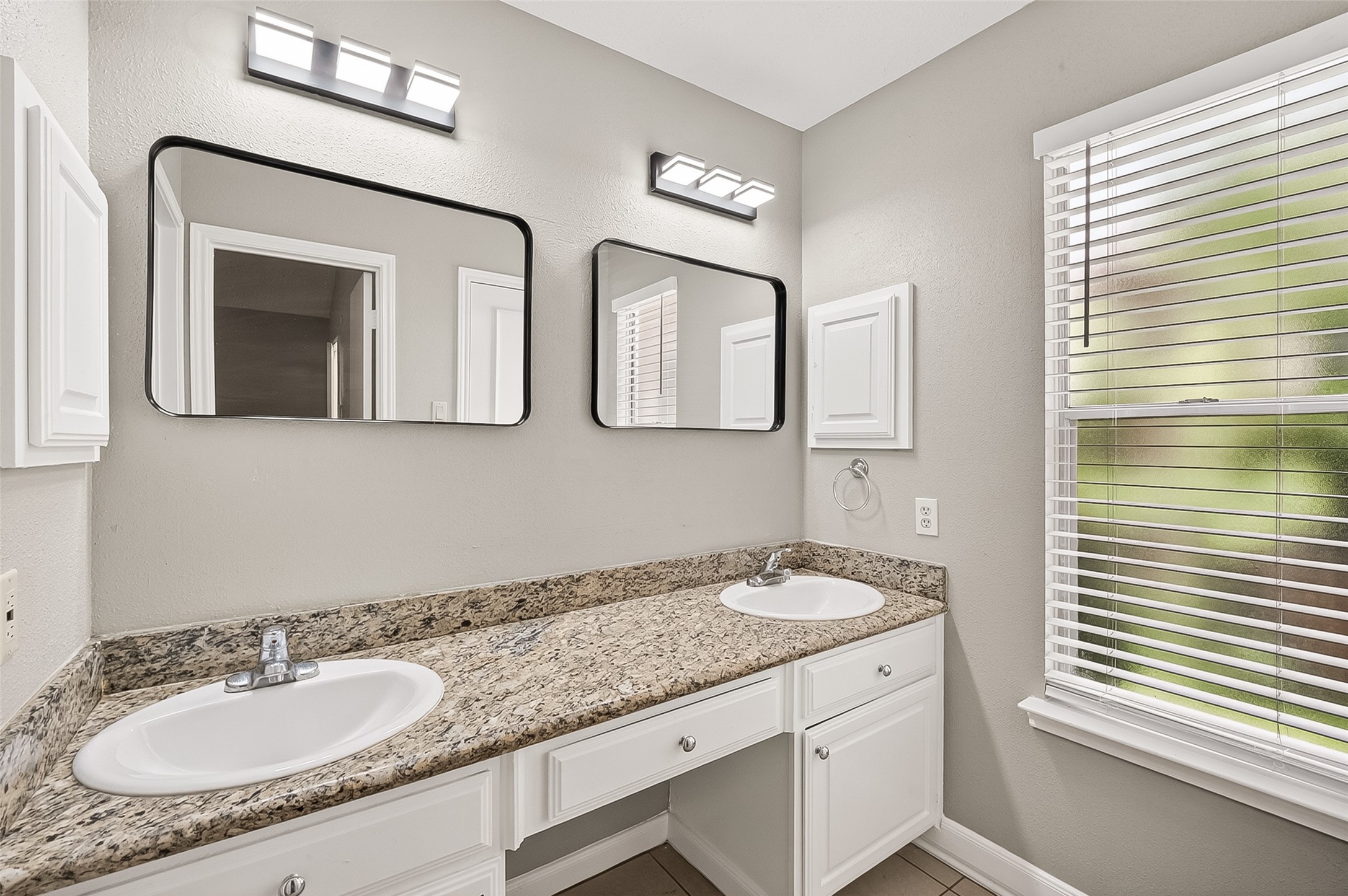 12403 Meadow Ridge Drive Stafford, TX 77477 - Photo 27 of 47 a bathroom with a granite countertop sink and a mirror