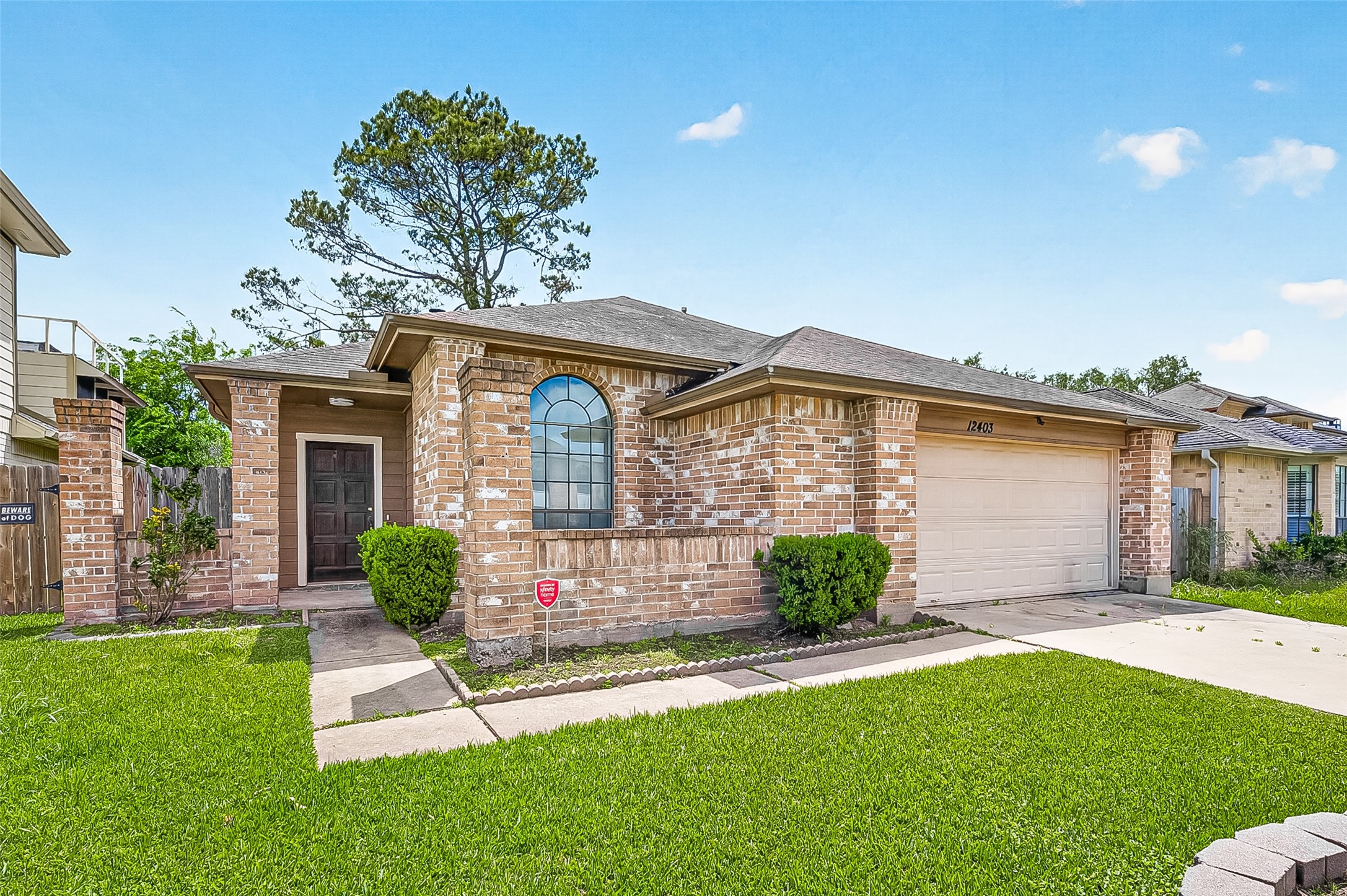 12403 Meadow Ridge Drive Stafford, TX 77477 - Photo 4 of 47 a front view of a house with a garden and plants